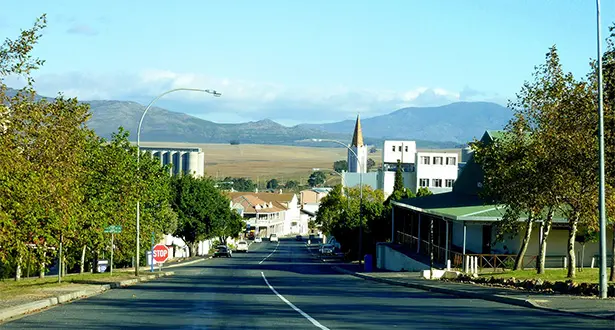 Small town street with church and mountains