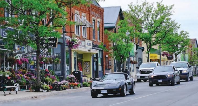 Small town main street with shops and cars